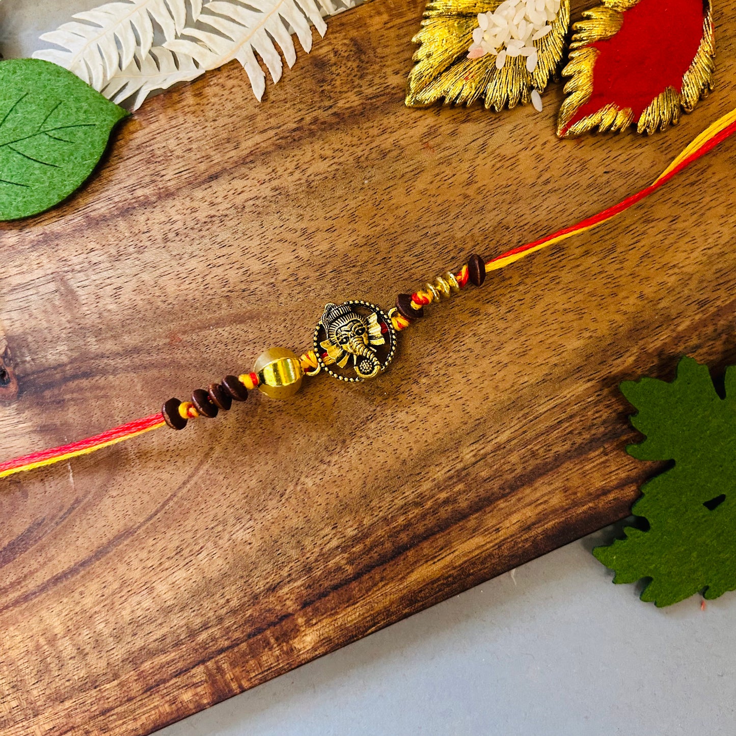 Ganeshji On Golden Circle & Beads Rakhi