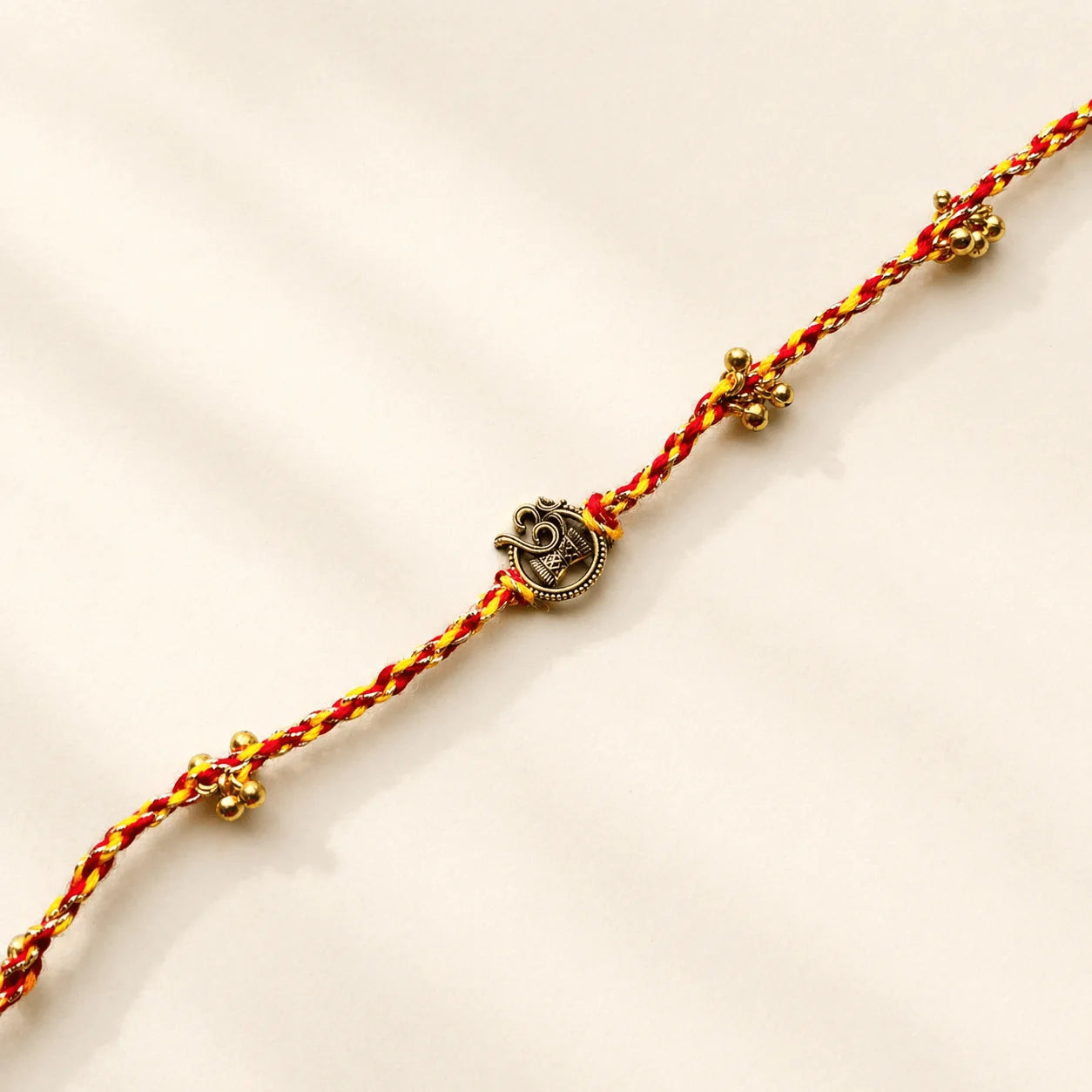 Om Damru Golden Charm Rakhi