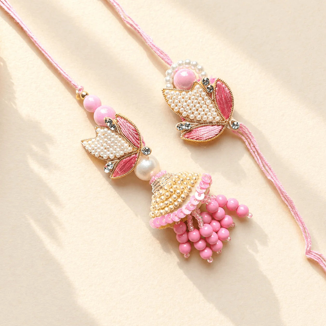 Pearl Leaf Pink Rakhi Set - handcrafted Rakhi & Lumba set for bhaiya-bhabhi | Traditions4u