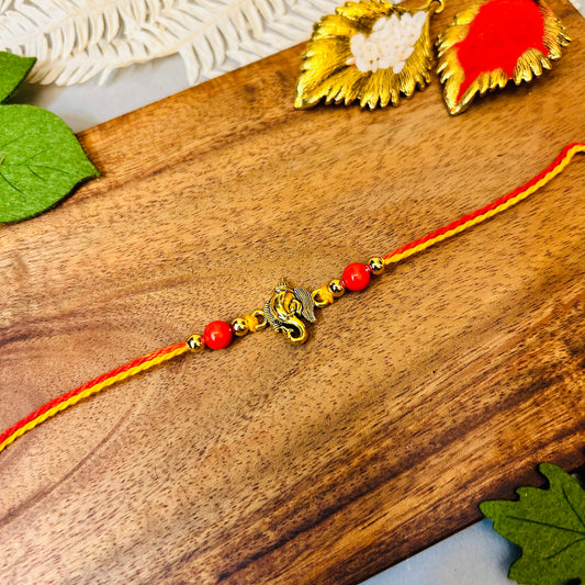 Golden Ganeshji & 2 Red Beads Rakhi