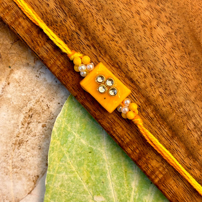 Stone Studded - handcrafted Sadi thread rakhi, design detail | Traditions4u
