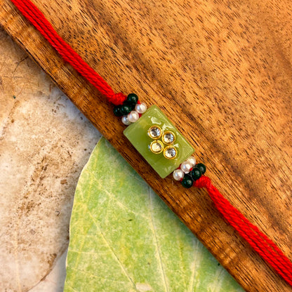 Stone Studded - handcrafted Sadi thread rakhi, close-up | Traditions4u