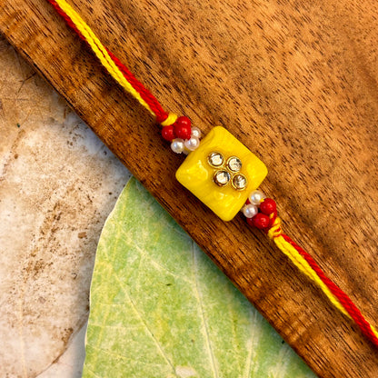 Stone Studded - handcrafted Sadi thread rakhi, styled view | Traditions4u